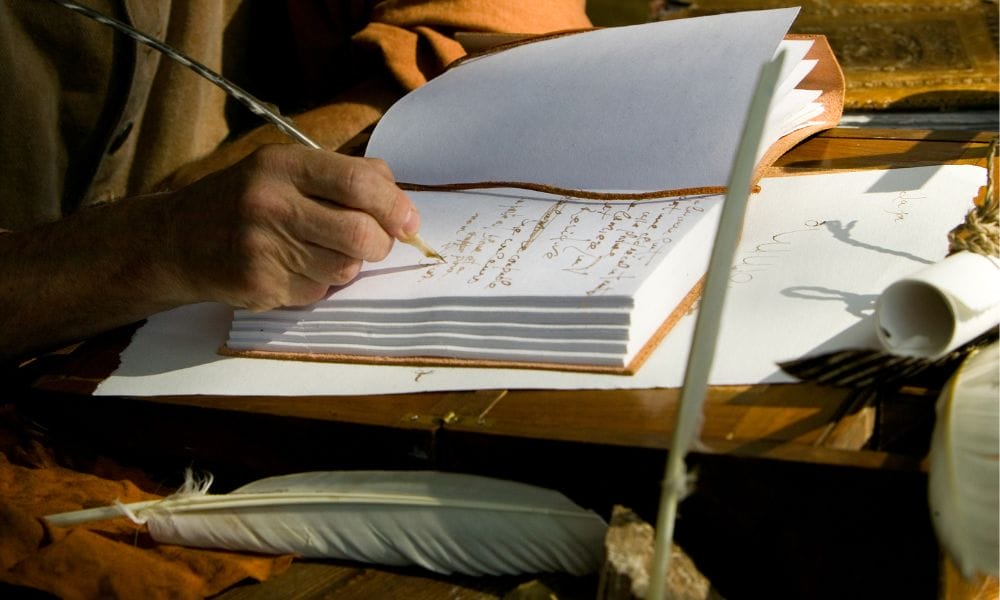 creative writing therapy image of man's hand writing in notebook